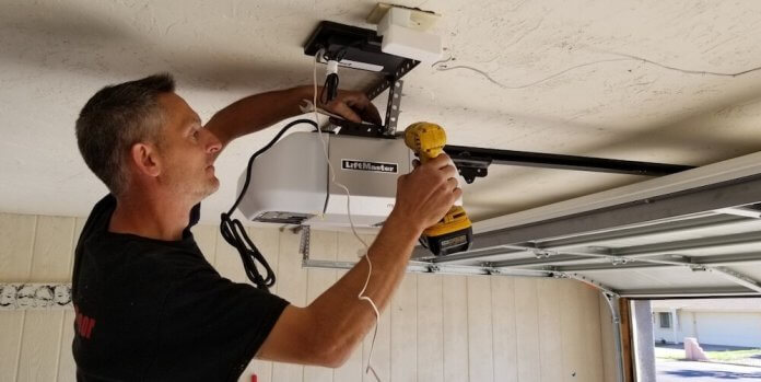 image of a man repairing a garage door