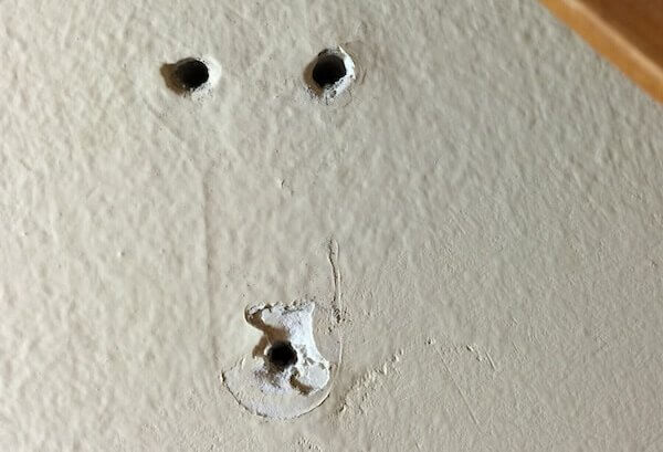 image of screw holes in drywall